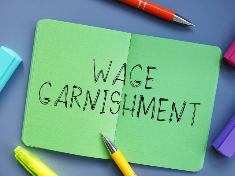 Financial concept meaning Wage Garnishment with sign on the shee